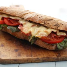 big-vegan-sandwich-with-vegetables-on-wooden-board-table